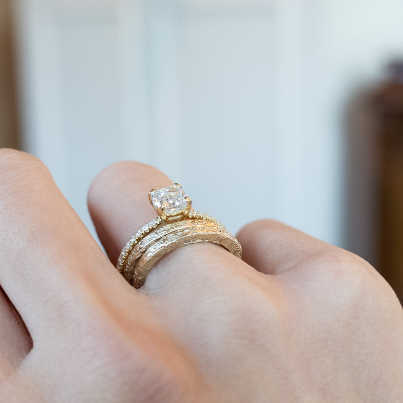 cushion cut diamond ring with pave set diamonds on ring