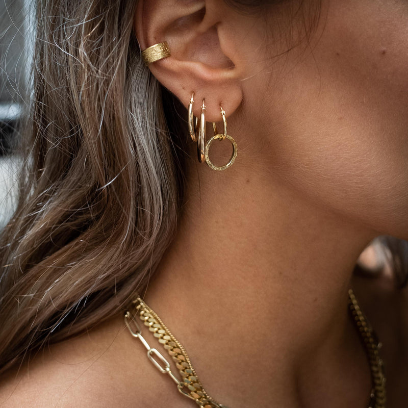 Ear with Melanie Pigeaud earrings, including ear cuff in 14k gold