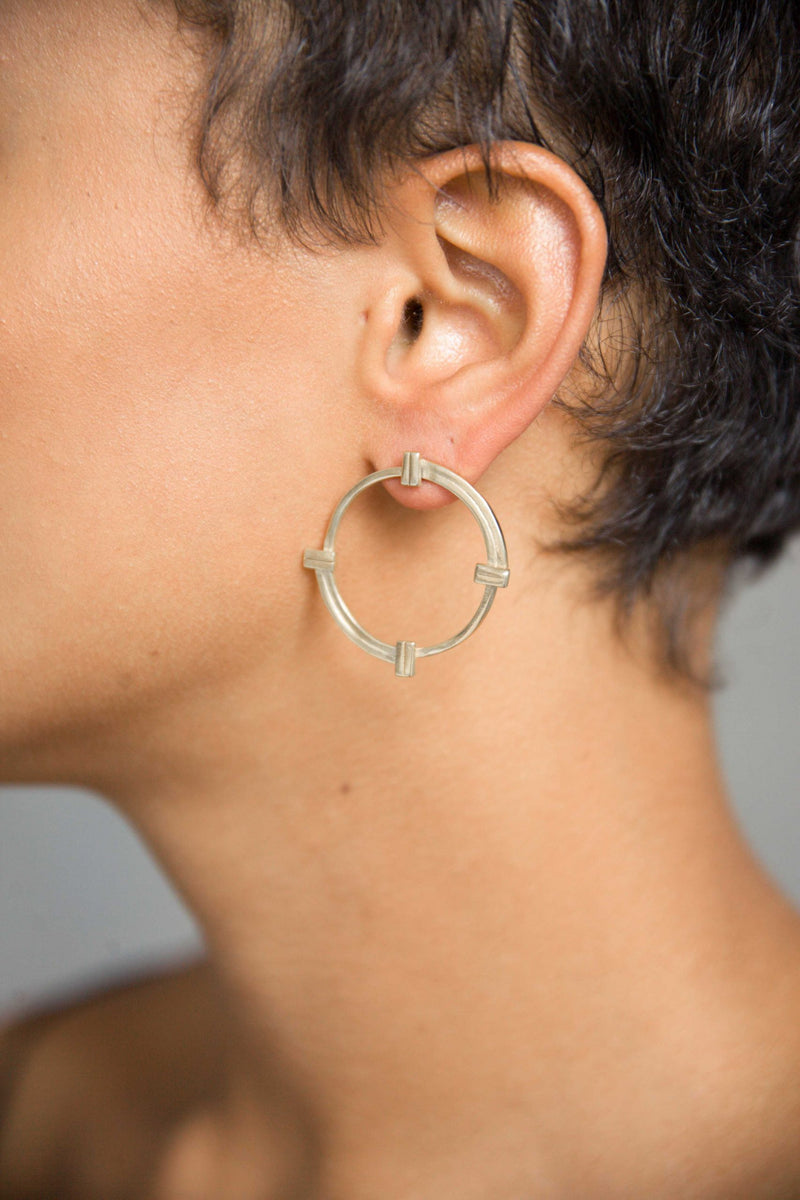 Model wearing Melanie Pigeaud imperfect balance big earring in sterling silver