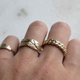 Hand with Melanie Pigeaud gold rings, including the Melanie Pigeaud chain ring in 14k gold
