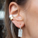 Ear with Melanie Pigeaud dream catcher earring in sterling silver and Melanie Pigeaud earcuffs in sterling silver and 14k gold