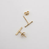 Melanie Pigeaud bamboo studs earrings in 9k gold lying down