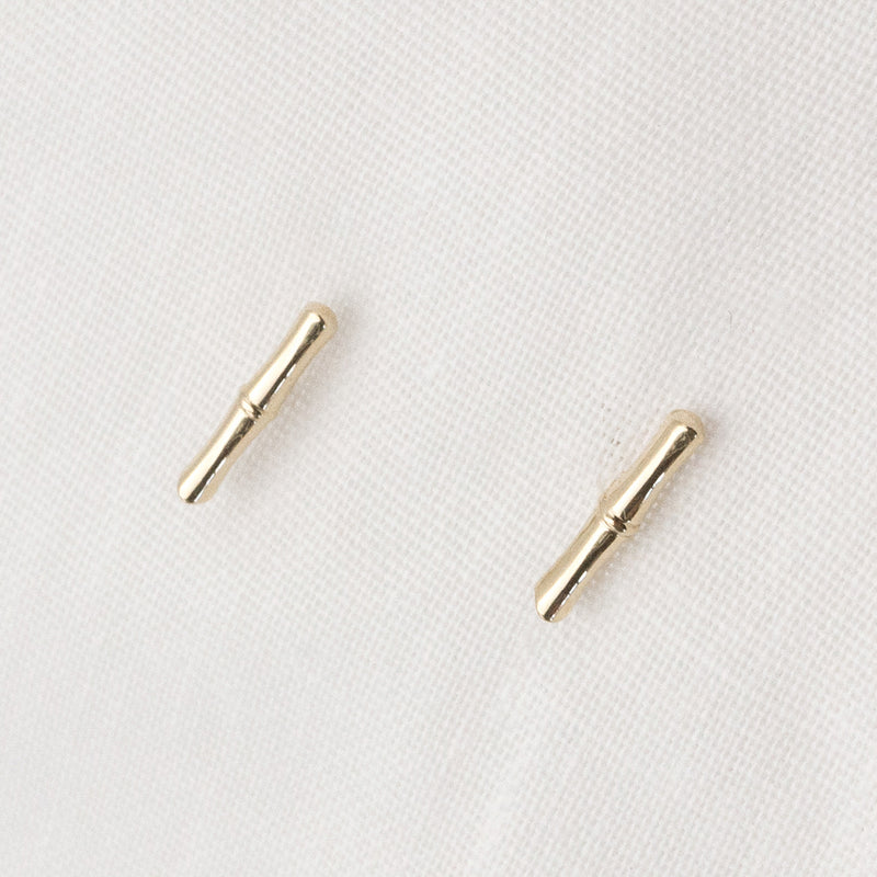 Front view Melanie Pigeaud bamboo studs earrings in 9k gold