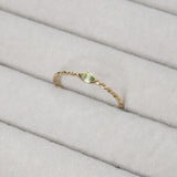 Close up Melanie Pigeaud peridot ring in 9k gold