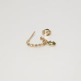 Singular Melanie Pigeaud rope earring with peridot stone in 9k gold lying down