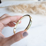 Squared Slave bracelet 14k gold by Melanie Pigeuad hold in hand