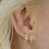 Ear with Melanie Pigeaud zirconia hoops earring in 9K gold and Melanie Pigeaud bamboo hoops earring in 9k gold
