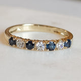 Close up Melanie Pigeaud sapphire zirconia row ring in 14k gold